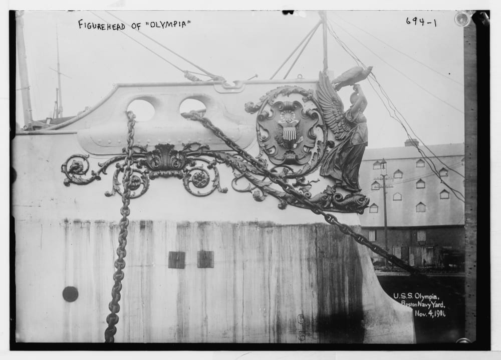 The carved eagle figurehead of USS Olympia, photographed at the Boston Navy Yard, Library of Congress Bain Collection.