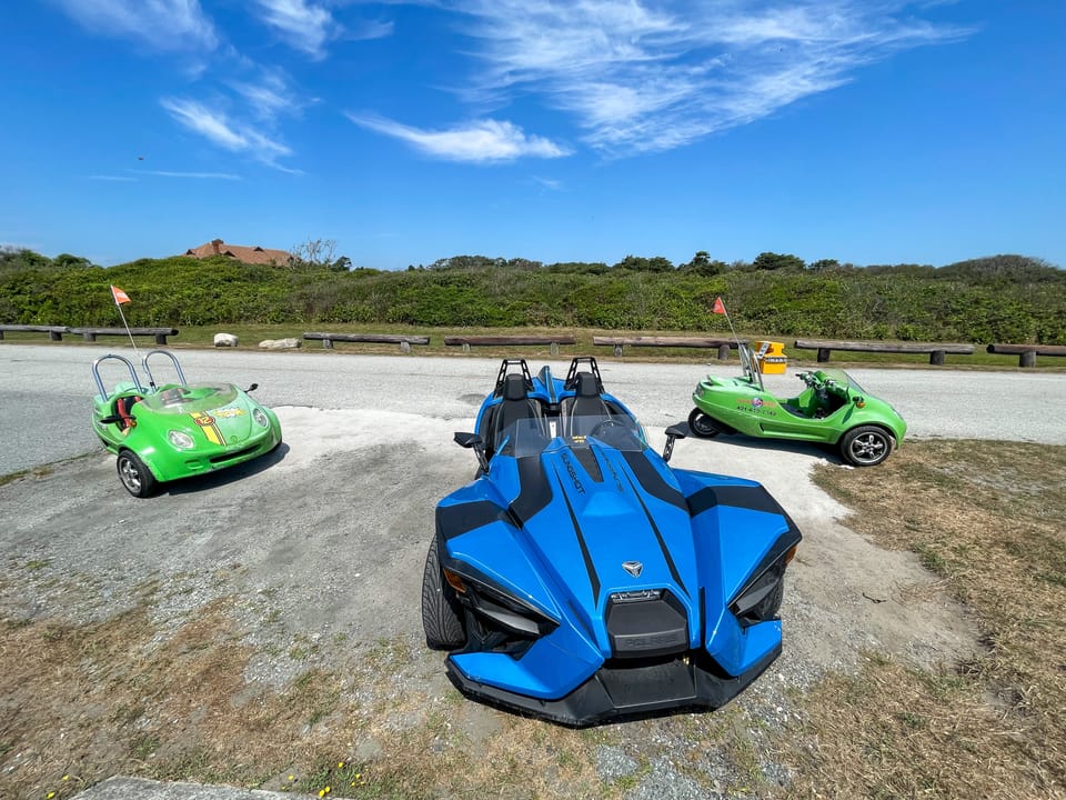 These odd vehicles are a common sight during the summer in Newport, Rhode Island. Two green "Scoot Coupes" and one blue "Polaris Slingshot". Taken at Brenton Point State Park, on Ocean Drive.