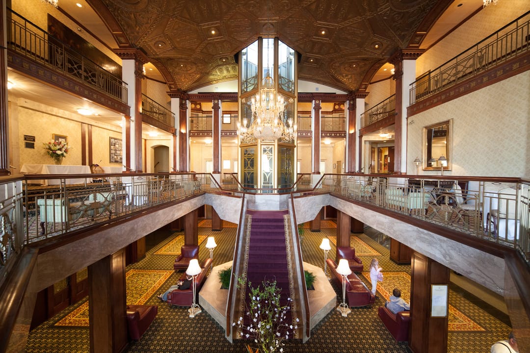 The grand lobby staircase and chandelier inside the Providence Biltmore Hotel (now Graduate Providence).