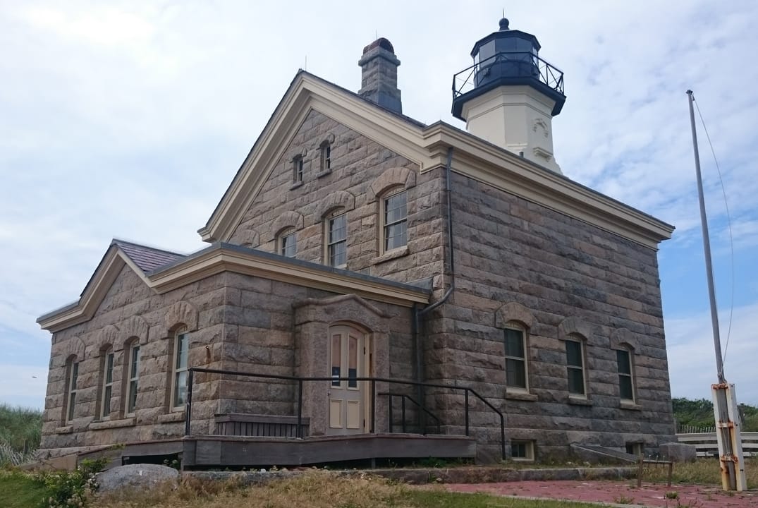 Block Island North Light, the lighthouse at Sandy Point, seen from the rear left, showing its twin chimneys and lantern.