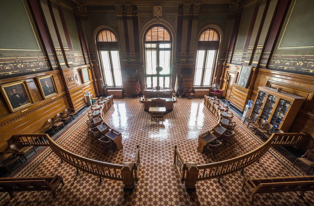 The Providence City Council Chambers inside City Hall, with its horseshoe wood dais, mosaic-tile floor and tall arched windows, 2014.