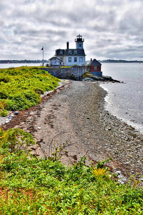 The cobble beach on Rose Island leading up to the lighthouse, with Narragansett Bay beyond.