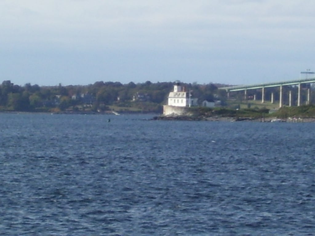 The Rose Island Lighthouse in Narragansett Bay near Newport, Rhode Island, a yellow-and-white 1869 lighthouse on a small island