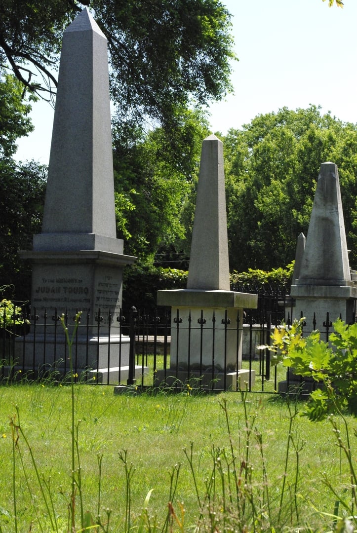 Headstones and Judah Touro's monument inside Touro Cemetery, North America's second-oldest Jewish burial ground in Newport, Rhode Island