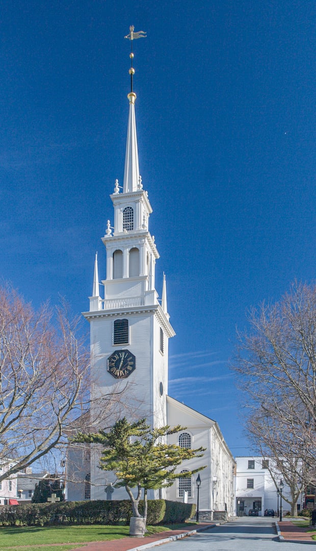 White-spired Georgian Trinity Church on Queen Anne Square, Newport, Rhode Island, with its colonial burying ground
