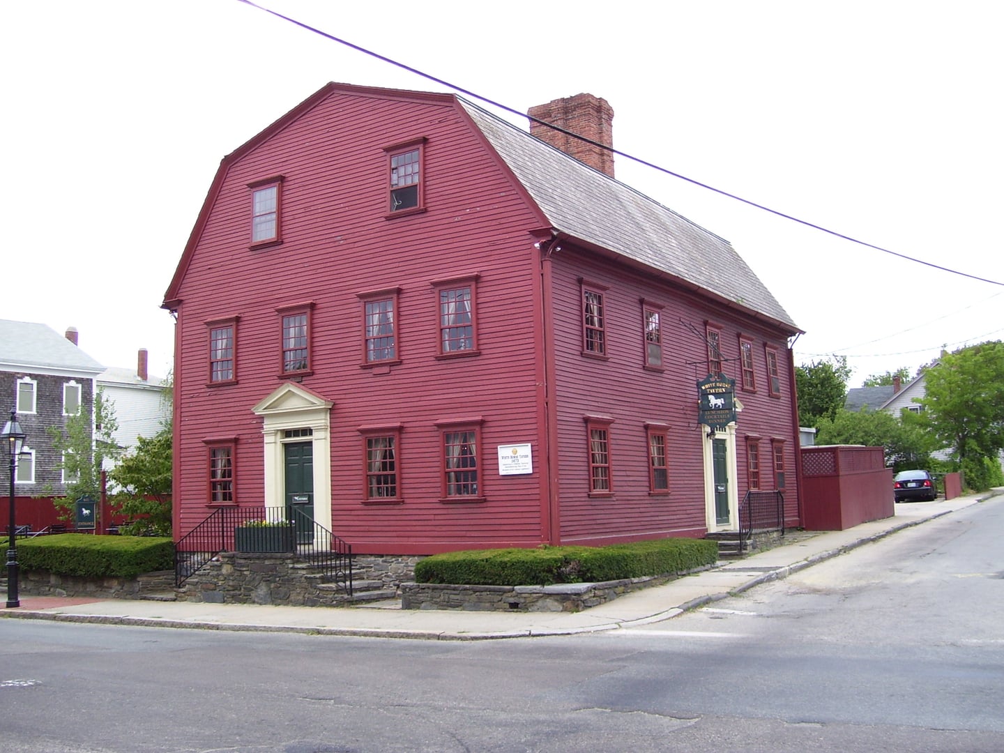 Red gambrel-roofed colonial White Horse Tavern at 26 Marlborough Street in Newport, Rhode Island