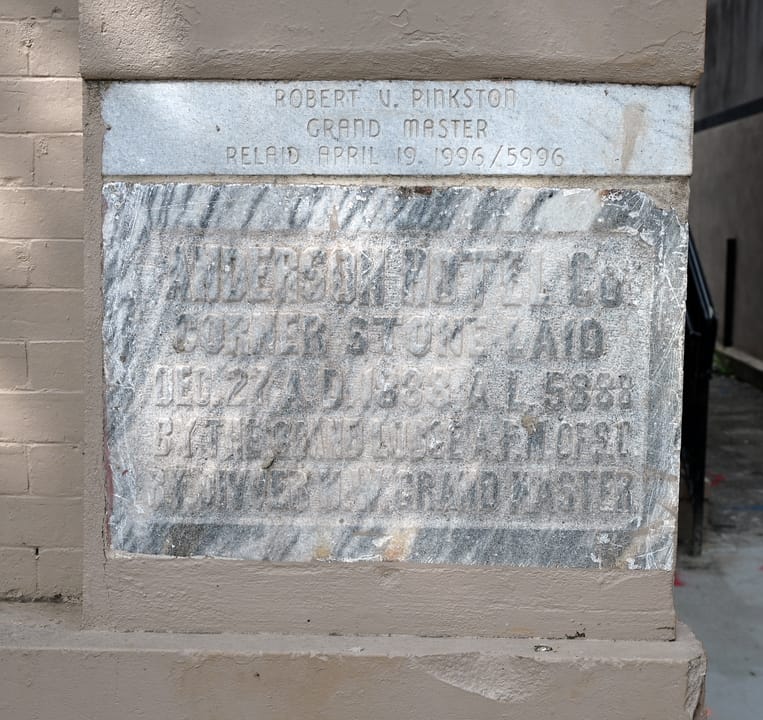 The hotel's 1888 cornerstone ('Corner stone laid Dec. 27 A.D. 1888'), with a 1996 Masonic re-laying plaque above it, Anderson, South Carolina.