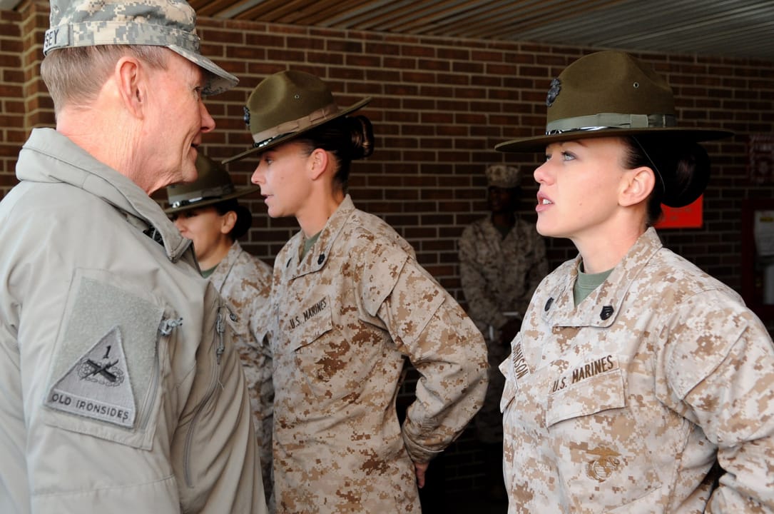 U.S. Army Gen. Martin E. Dempsey, left, the chairman of the Joint Chiefs of Staff, talks with U.S. Marine Corps Staff Sgt. Melissa Johnson, a drill instructor, while touring facilities of the 4th Recruit Training Battalion at Marine Corps Recruit Depot Parris Island, S.C., March 21, 2013. (DoD photo