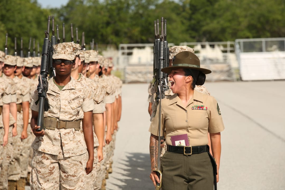 U.S. Marine Corps Staff Sgt. Caroline Chavez, a senior drill instructor assigned to Platoon 4023, November Company, 4th Recruit Training Battalion, commands her platoon during their final drill evaluation, June 25, 2014, at Parris Island, S.C. Chavez directed the recruits to perform a series of prec