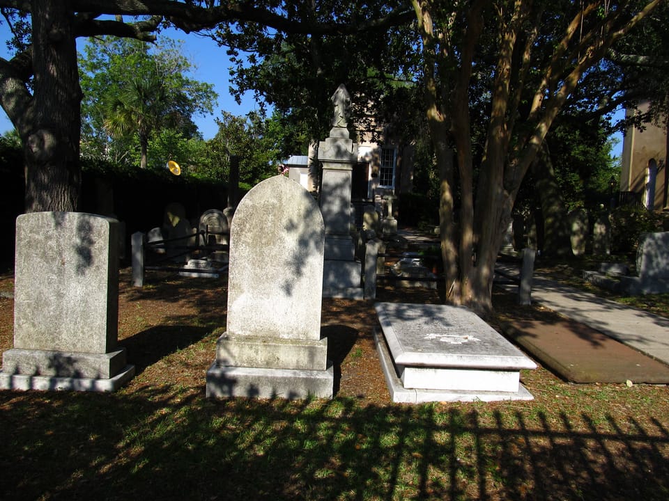 Weathered headstones and a box tomb beneath live oaks in St. Philip's Episcopal Church graveyard, Charleston, South Carolina, 2011.