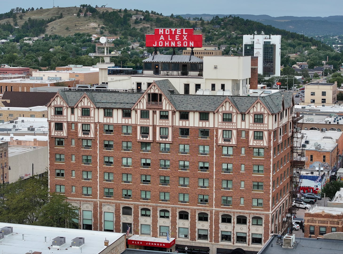 Exterior of the Hotel Alex Johnson, a historic brick Tudor-style hotel in downtown Rapid City, South Dakota