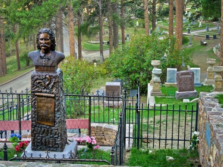Wild Bill Hickok's grave marker on a hillside overlooking Mount Moriah Cemetery above Deadwood, South Dakota