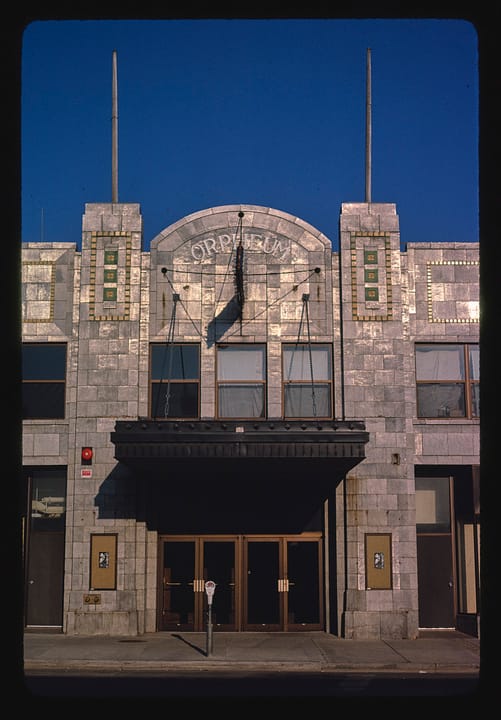The Orpheum Theatre's front on North Phillips Avenue in Sioux Falls, South Dakota, seen straight on in 1980, with its arched ORPHEUM pediment, tiled towers and marquee.