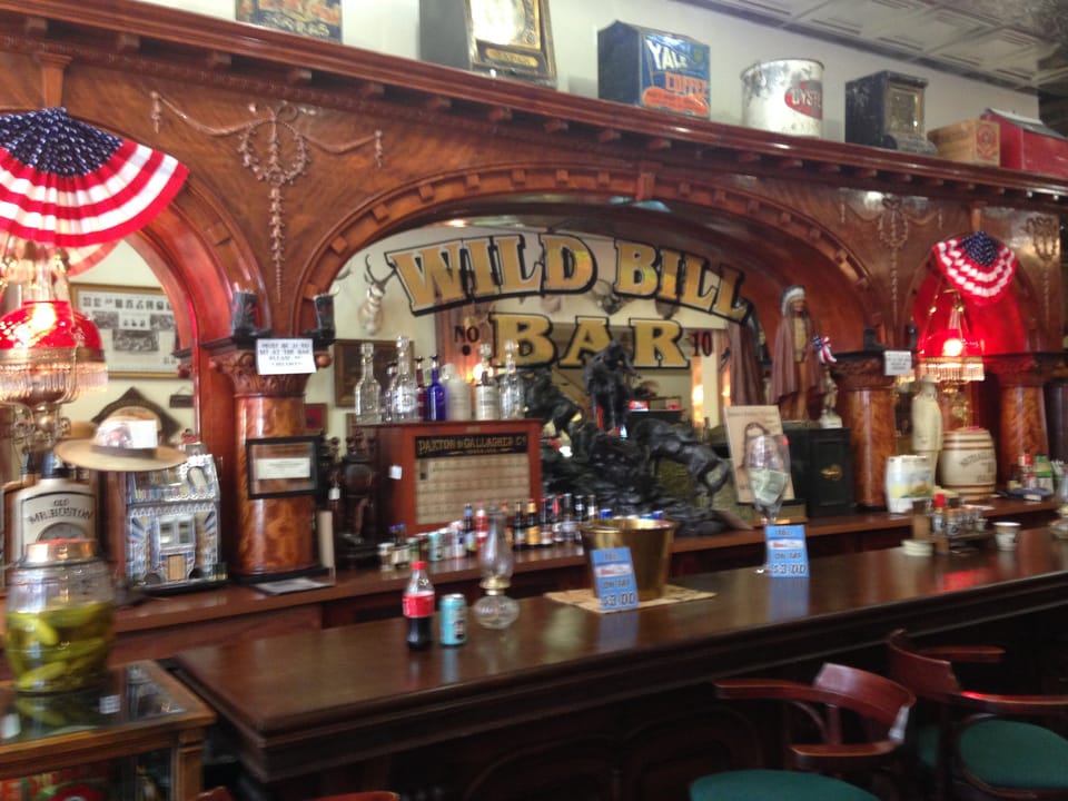 The back bar of the Wild Bill Bar in Deadwood, South Dakota, with mounted taxidermy and antique bar fixtures.