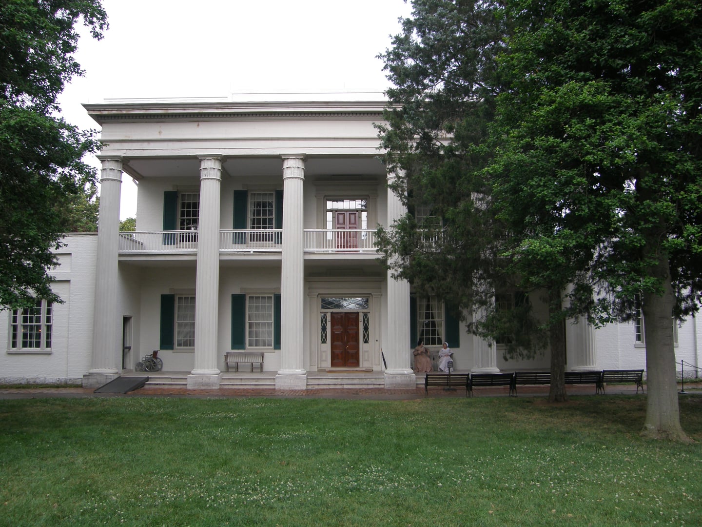 Andrew Jackson's Hermitage Greek Revival mansion exterior with white columned portico framed by trees in Nashville, Tennessee