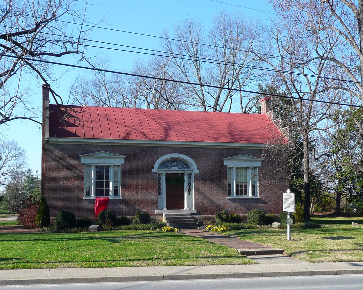 Front facade of the Carter House in Franklin, Tennessee, a brick Federal-style antebellum home with visible bullet-pocked exterior