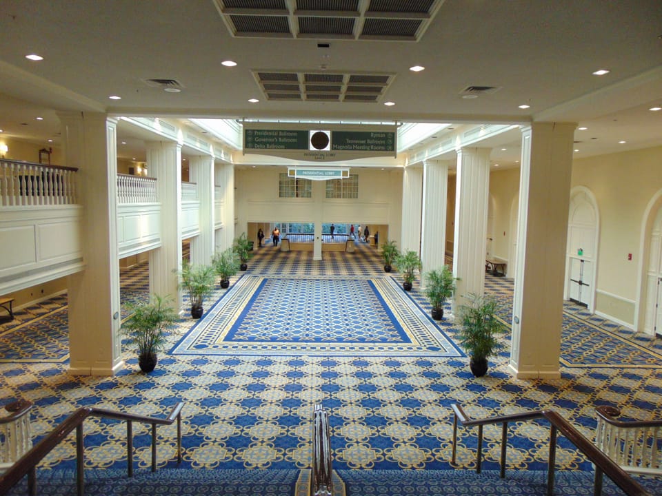 Presidential Lobby interior at the Gaylord Opryland Resort, a long columned atrium walkway with a blue-and-tan patterned carpet, August 2017.