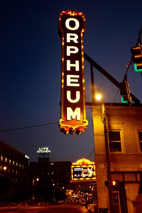The Orpheum Theatre's vertical 'ORPHEUM' sign lit up at night on South Main Street, Memphis.
