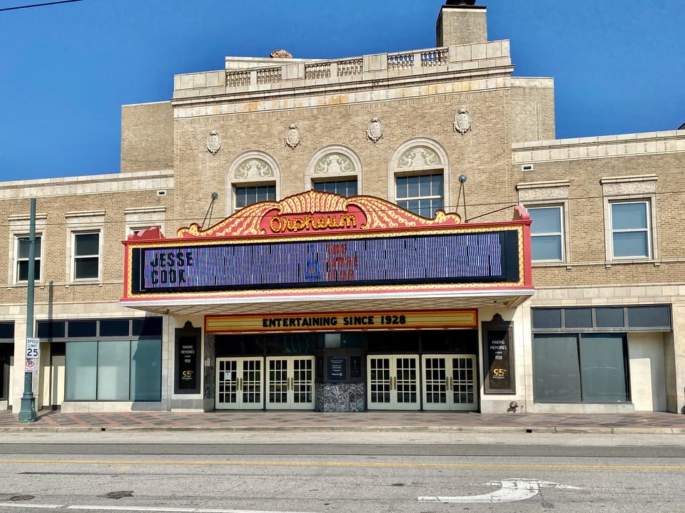The Orpheum Theatre's Main Street facade in daylight, with its marquee reading "Entertaining Since 1928."