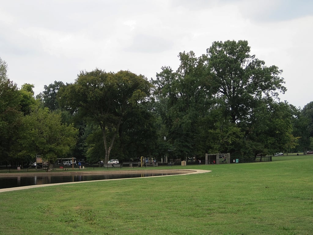 Rainbow Lake in Memphis's Overton Park with playground area visible through trees
