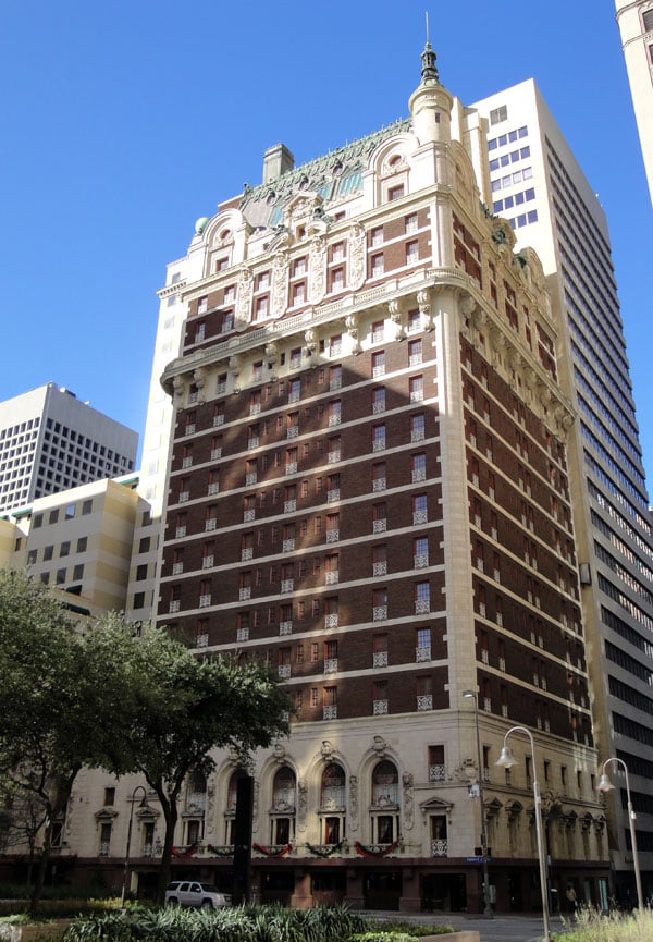 Beaux Arts brick-and-stone facade of the 1912 Adolphus Hotel rising 22 stories above Commerce Street in downtown Dallas, Texas