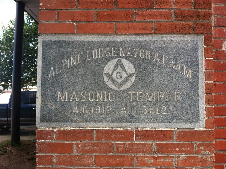 Cornerstone on the northwest corner of the Hancock Building with text stating "Alpine Lodge No. 766 A.F. &amp; A.M. Masonic Temple A.D. 1912. A.L. 5912."