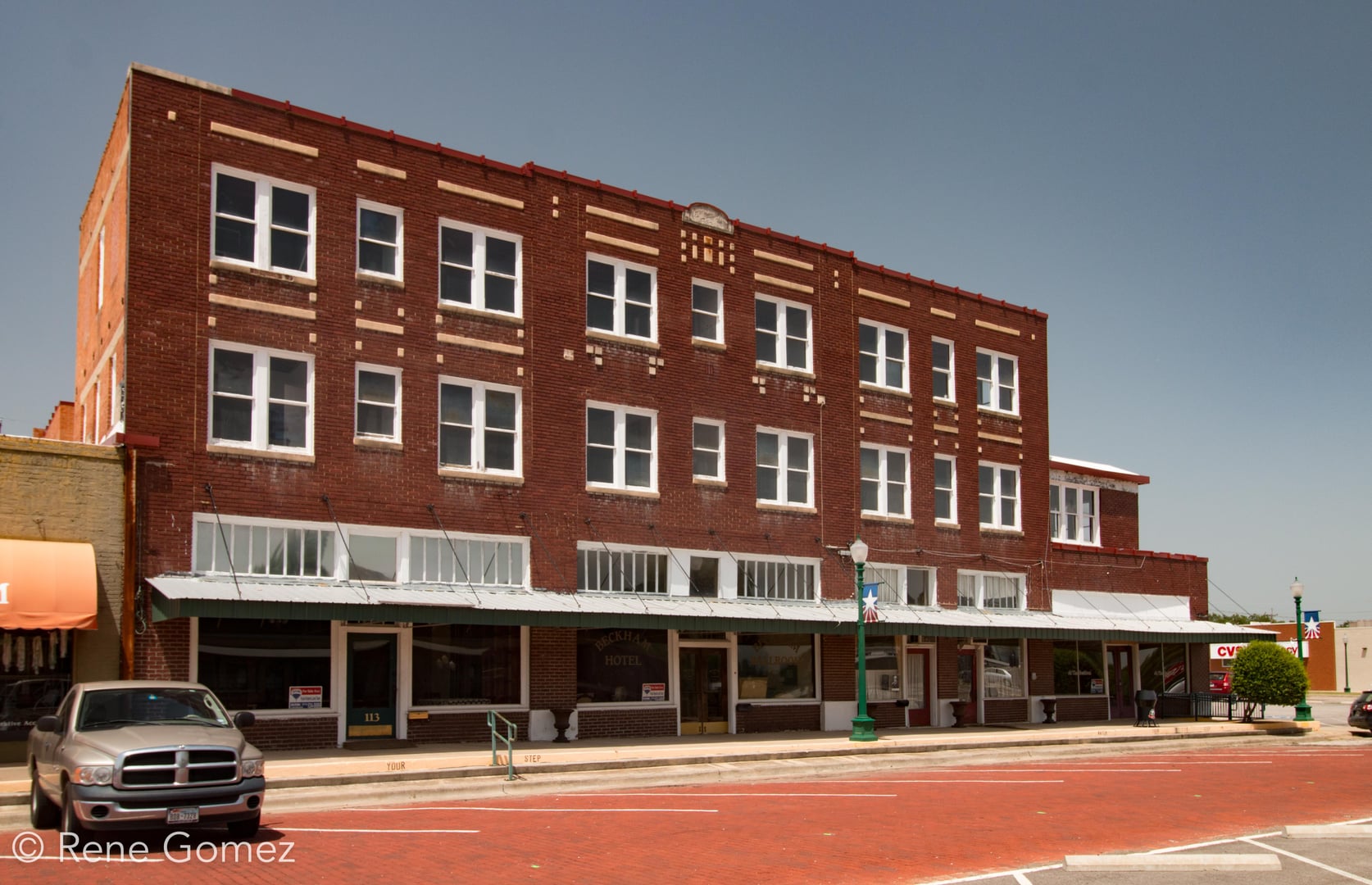 Three-story brick Beckham Hotel building on E Commerce Street in Mineola, Texas