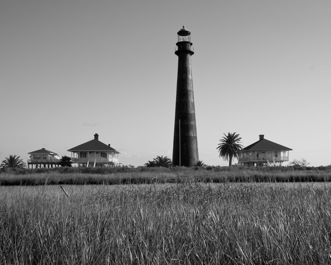 The 116-foot black iron Bolivar Point Lighthouse on the flat Texas peninsula, visible from Highway 87