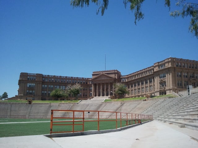 Neoclassical facade of El Paso High School on the hillside above E Schuster Ave, designed by Henry C. Trost in 1916