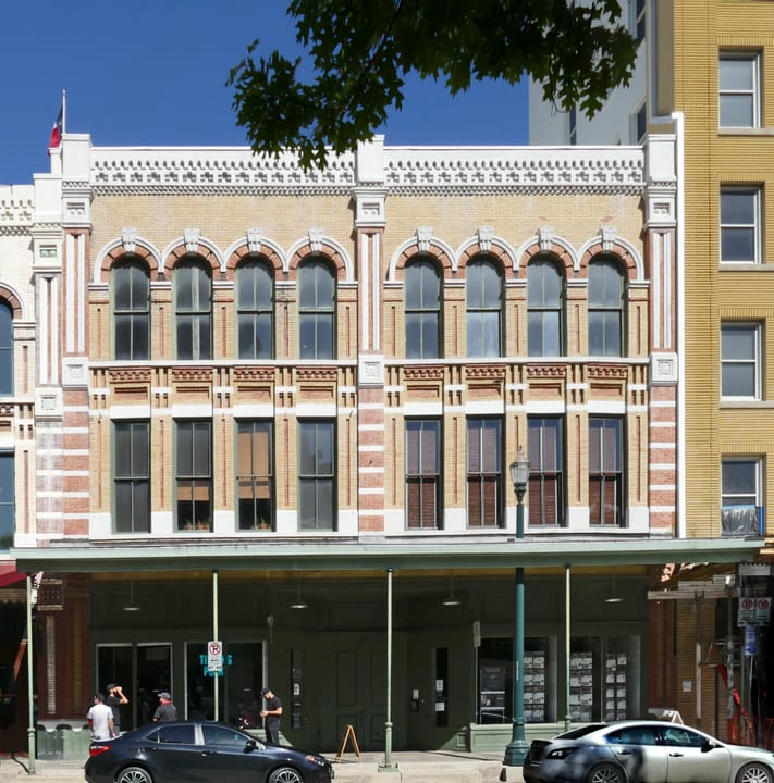 John Kennedy (d. 1878), who had a trading post for frontiersmen and Indians in Houston as early as 1841, built the oldest part of this structure as investment property in 1860. After half of the building burned, his son-in-law, W. L. Foley (d. 1925), rebuilt the lost portion in 1889, giving old and 