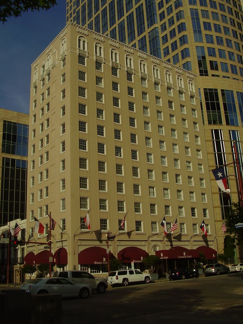 The twelve-story 1926 Lancaster Hotel (formerly the Auditorium Hotel) on Texas Avenue in downtown Houston, Texas, with Texas flags and marquee canopy visible