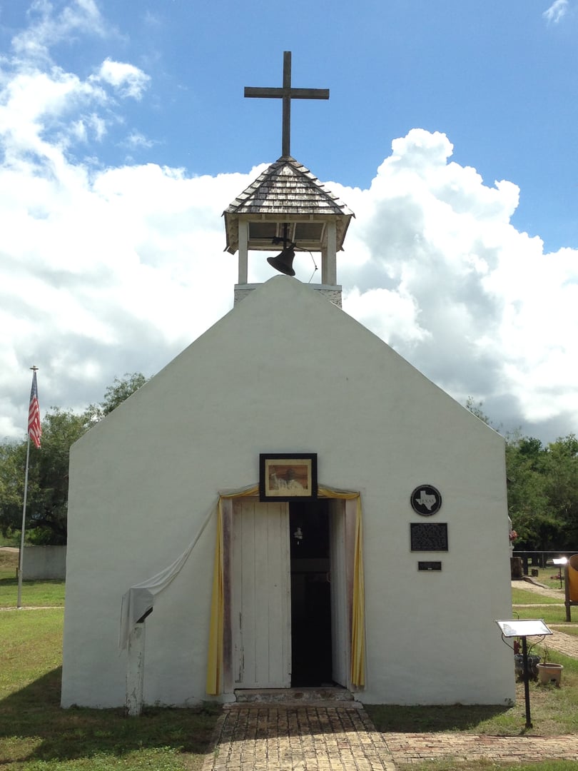 La Lomita Chapel, a small historic Catholic chapel near Mission, Texas, with stucco walls and a simple cross