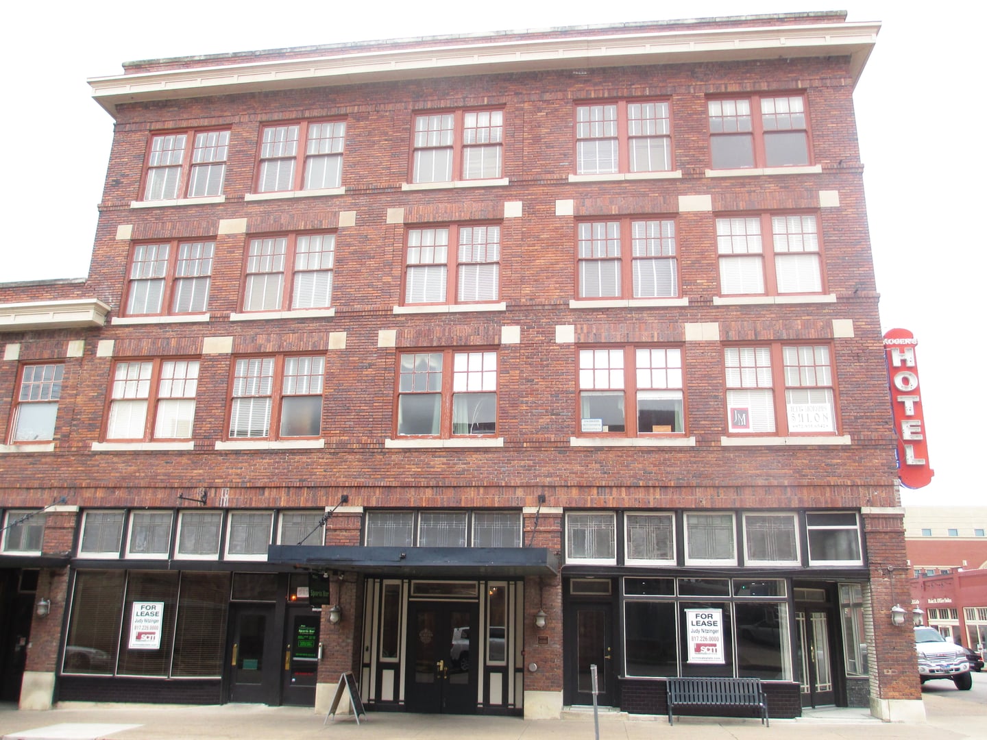 Four-story brick Rogers Hotel building on a downtown corner in Waxahachie, Texas, photographed in 2012