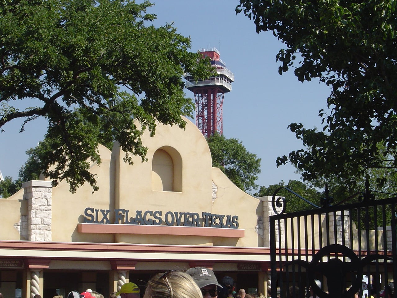 The entrance of Six Flags Over Texas in Arlington with the Oil Derrick observation tower visible in the background