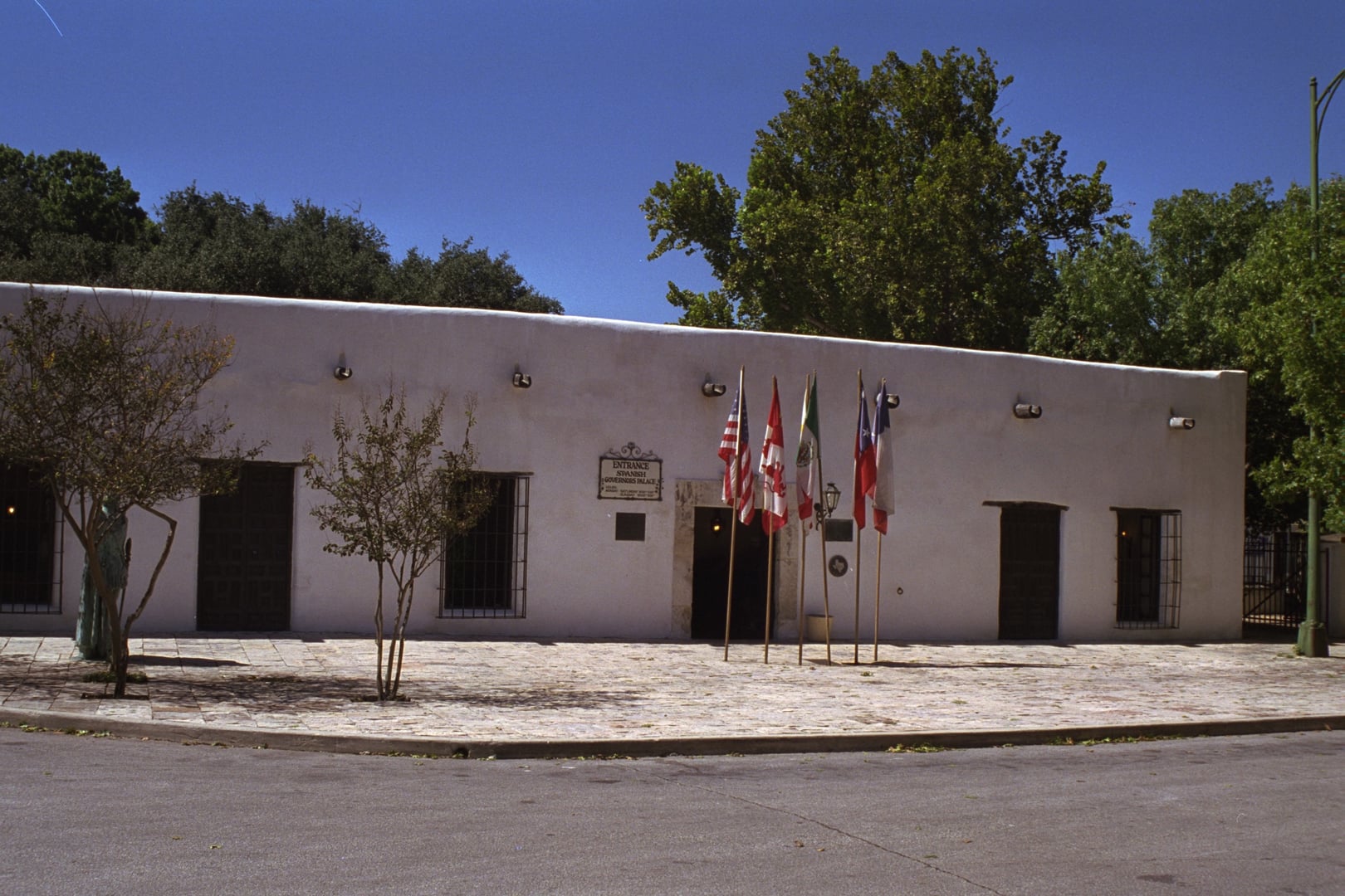 Spanish Governor's Palace 1749 adobe colonial facade with whitewashed walls and wooden doors on Plaza de Armas in San Antonio