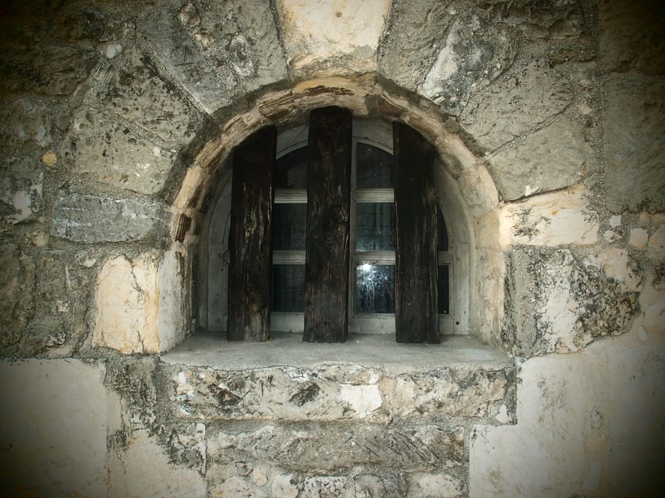 A barred window on the Alamo's Long Barracks, the former mission offices where defenders made their final stand in the 1836 battle