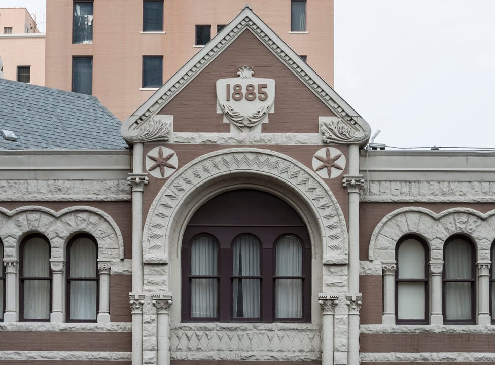 Carved '1885' datestone and pediment detail above the Driskill's Brazos Street entrance, Austin, Texas; photographed 2014.