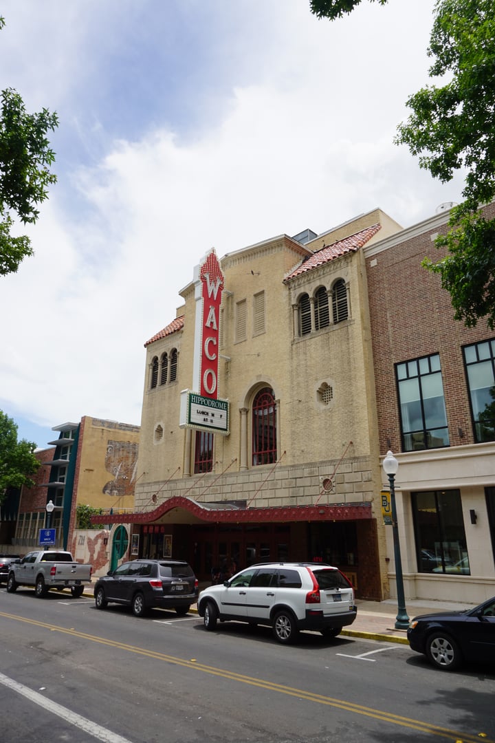 Exterior facade of the Waco Hippodrome Theatre on Austin Avenue, showing the Spanish Colonial Revival architecture added in the 1929 rebuild after the 1928 fire