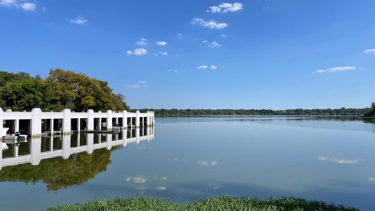 The White Rock Lake spillway, with its distinctive white colonnade railing, on a clear day, September 2022.
