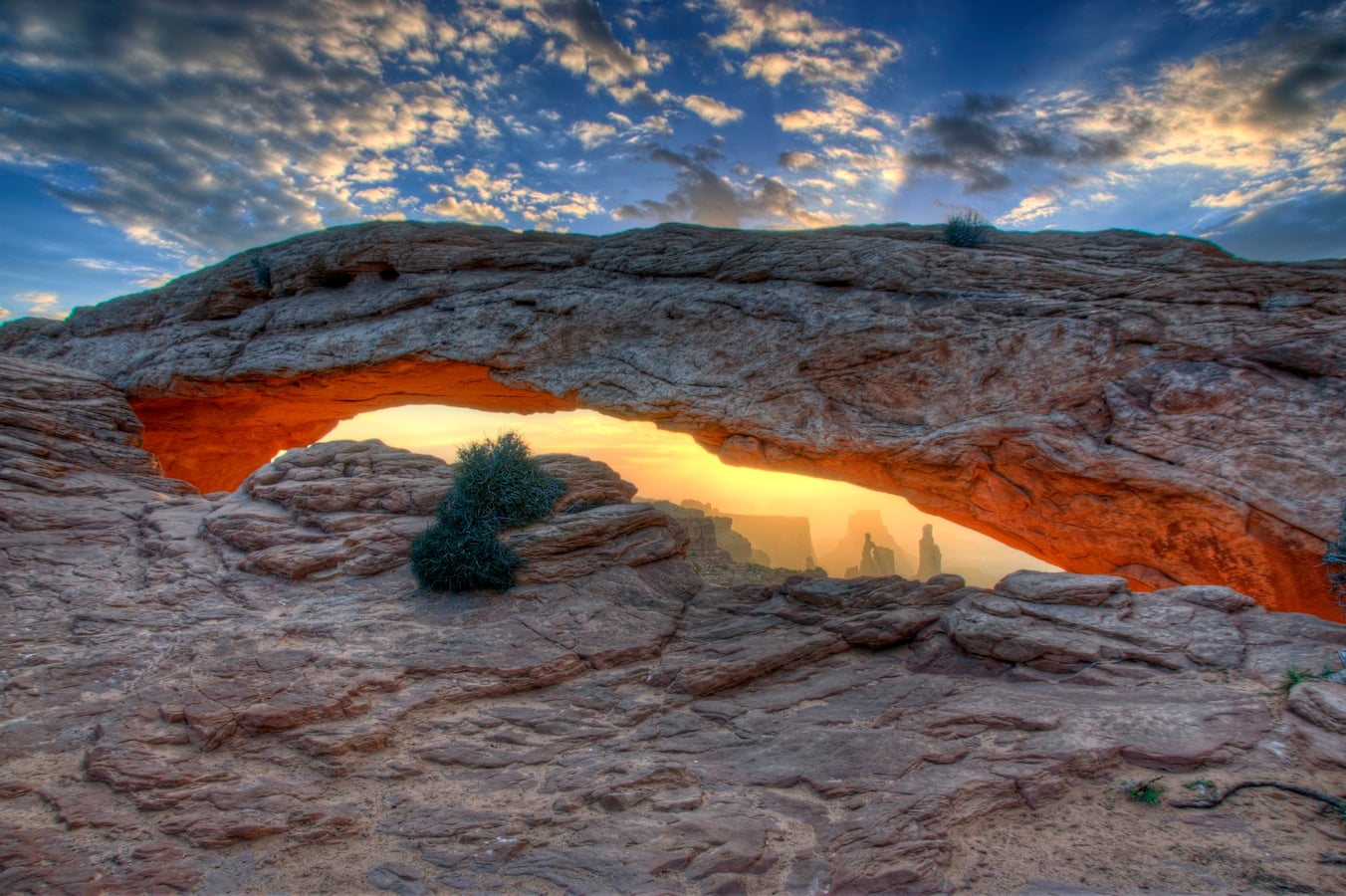 Mesa Arch at sunrise framing the canyon country of Canyonlands National Park's Island in the Sky district in southeastern Utah