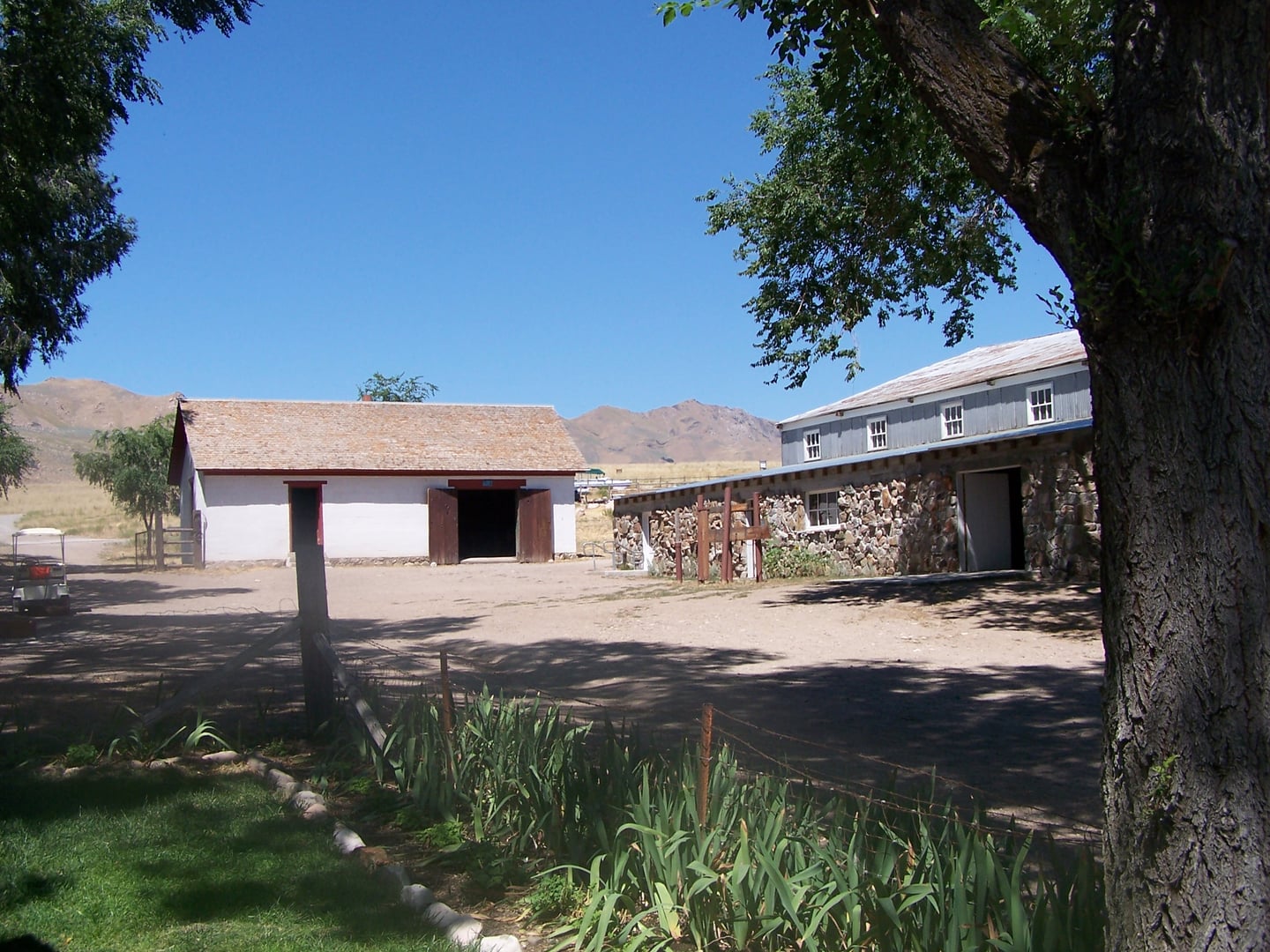 Fielding Garr Ranch on Antelope Island, Utah — the 1848 adobe ranch house and outbuildings set against the Wasatch Mountains and the Great Salt Lake