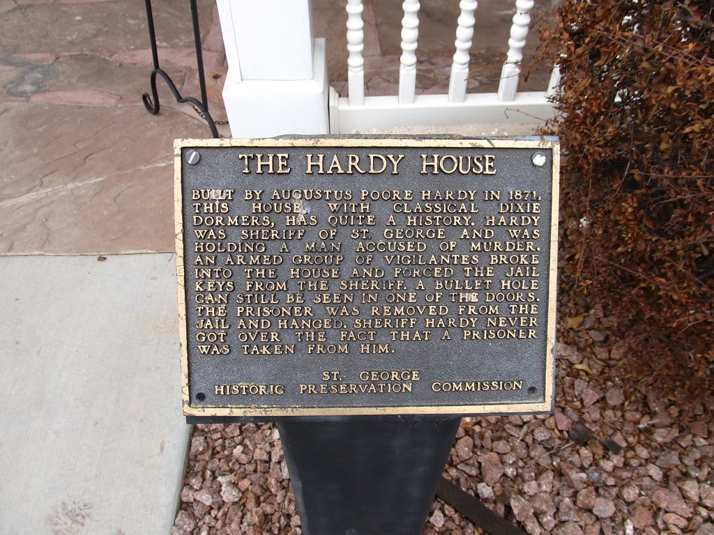 Exterior of the Augustus Hardy House at 46 West St. George Boulevard in Ancestor Square, St. George, Utah — an 1871 basalt and adobe structure with classical Dixie dormers