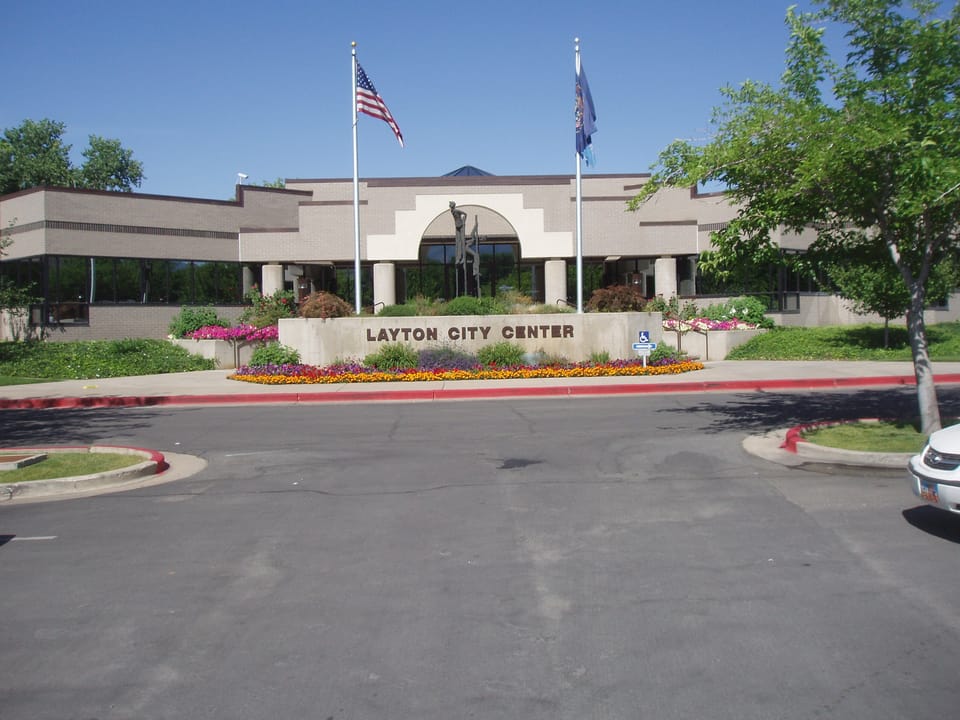 Layton Commons Park in Layton, Utah, with green lawn and recreational paths on the former Verdeland Park site