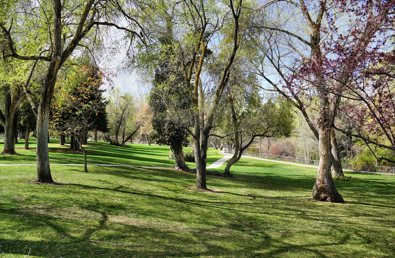 Layton Commons Park in Layton, Utah, with green lawn and recreational paths on the former Verdeland Park site