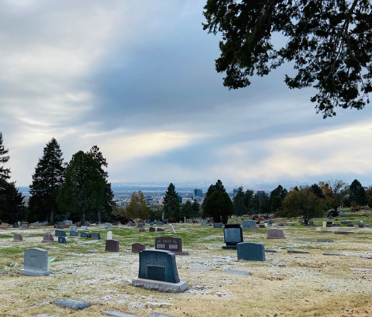 Salt Lake City Cemetery in fall, showing headstones across the 120-acre grounds with the Avenues neighborhood beyond