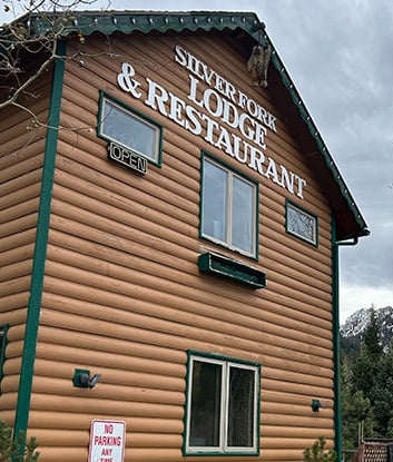 Silver Fork Lodge exterior in Big Cottonwood Canyon, showing the historic 1947 timber mountain retreat surrounded by Wasatch pines