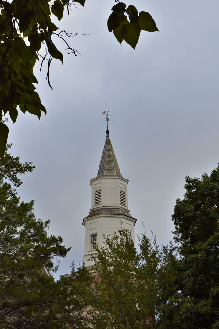 Exterior of Bruton Parish Church with white steeple, Colonial Williamsburg, Virginia