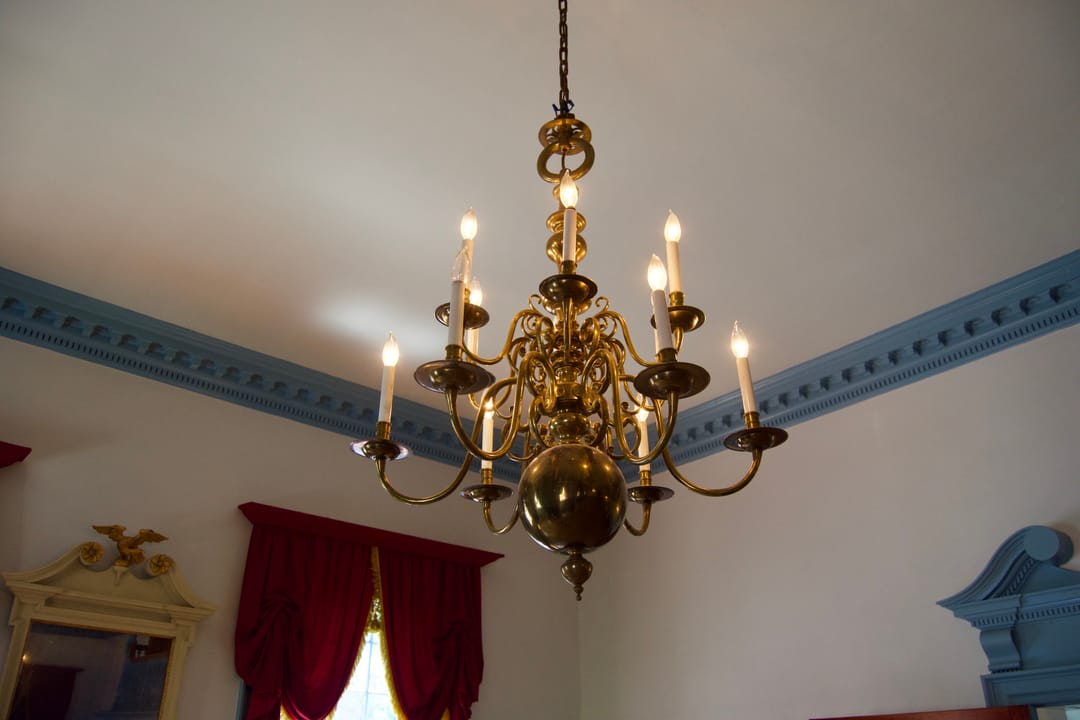 A period brass chandelier in a bedroom of Gadsby's Tavern Museum.