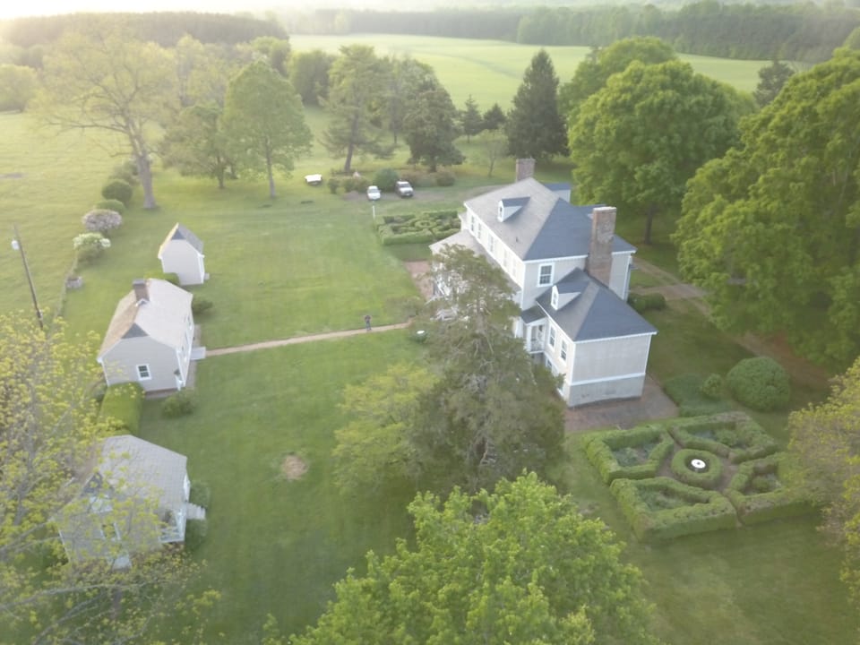 This view show the courtyard and dependencies behind Haw Branch. The schoolhouse, kitchen, and smokehouse are in the left hand side of the image.