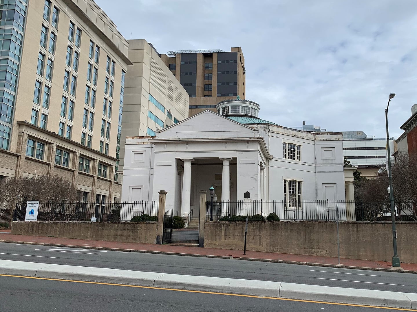 Greek Revival exterior of Monumental Church at 1224 East Broad Street, Richmond Virginia, with stone memorial portico and octagonal sanctuary dome